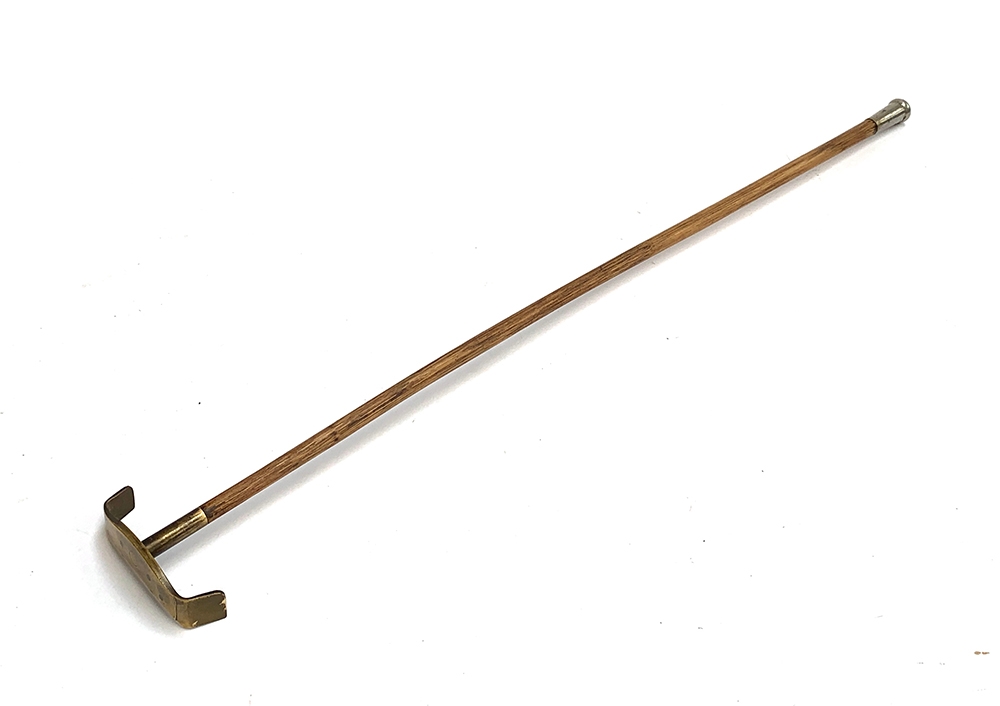 An early 20th century croupier stick, with brass end and plated knop, 66.5cm long