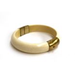 A 19th century ivory and brass bangle, 7.5cmD