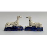 A pair of small Staffordshire recumbent greyhound pen stands, with spot decoration, each 11.5cmL