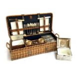 A vintage wicker picnic hamper, with fitted interior with contents, including four ceramic lined tin
