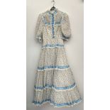 A late 20th century coming out dress, made by Regamus, with a silk tie