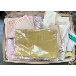A box of miscellaneous materials, table cloths, and table runners, mostly unused