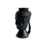 A carved African anthropomorphic palm wine cup, possibly Kuba art, depicting three overlapping