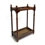 An oak umbrella/stick stand, three divisions, with drip tray, 71cm high