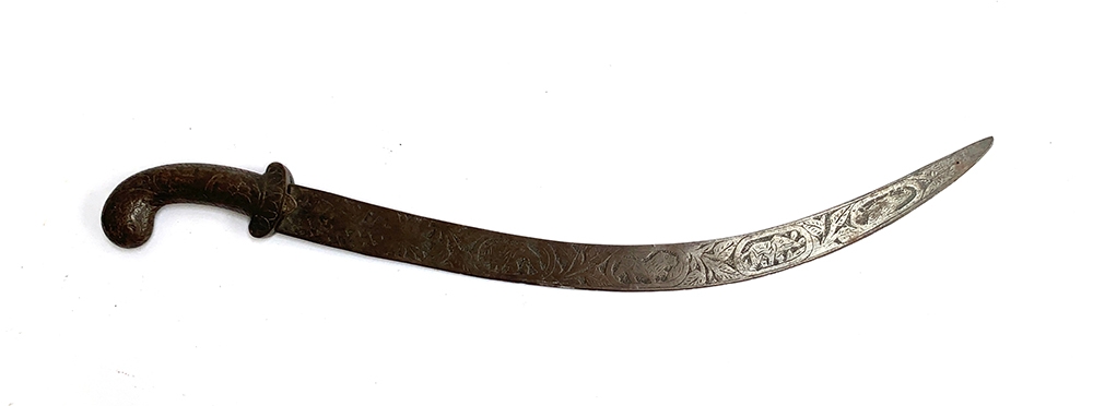 An Indo-Persian Shamshir scimitar, worked pistol hilt, the blade worked with various animals