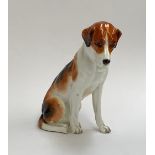 A Royal Worcester figure of a seated foxhound, 17cm high