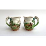A pair of jugs by Wedgwood 'Dye Ken John Peel', with hunting scenes and fox hound handles,