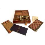 A 19th century mahogany cased compendium of games to include chess and backgammon boards and pieces;