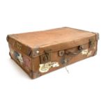 A vintage suitcase, with leather corner fittings, various travel stickers including Weymouth, Cunard