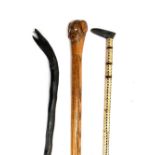 A shark vertebrae walking cane; together with an ebonized cane with serpent's head knop; and one