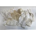 A mixed lot of lace and linen children's and dolls clothes; an early French chemise; stiff