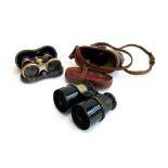 A pair of late 19th/early 20th century small binoculars in a leather case; together with a pair of