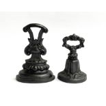 Two cast iron Coalbrookdale style door stops, 23cm high and 18cm high (2)