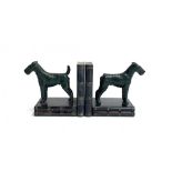 A pair of bronze and cast metal book ends, in the form of standing fox terriers, 13cm high, one with