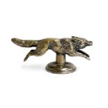 A brass car mascot in the form of a running fox, 12cm long