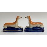 A pair of Staffordshire recumbent greyhound pen holders, each 17cmL