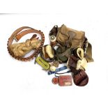 A mixed lot of items including a leather cartridge belt with brass buckle, wrist warmer, various