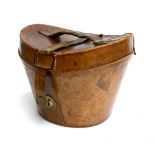 A brown leather top hat box, fitted striped interior