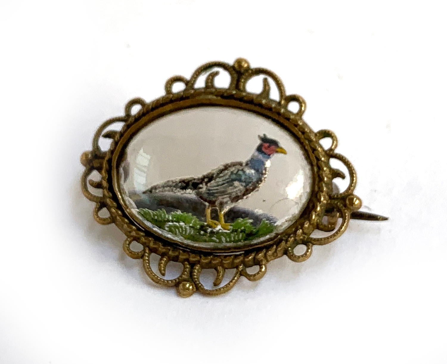 An Essex crystal brooch, with reverse carving depicting a pheasant, approx. 3cmW