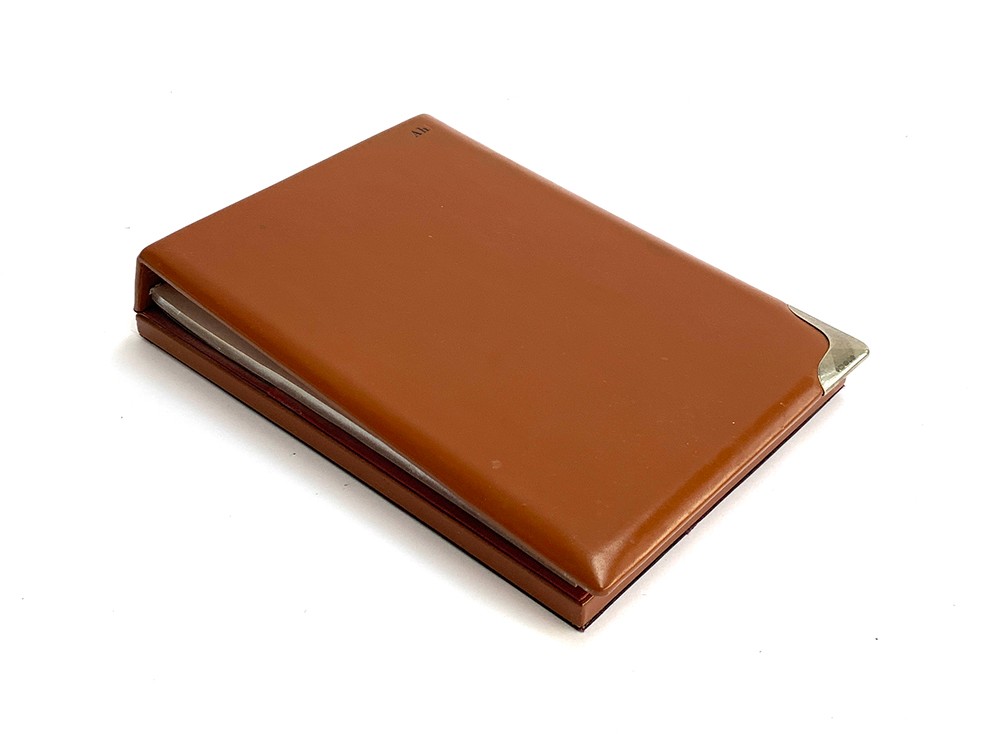 An Asprey leather jotter with silver corner mount