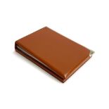 An Asprey leather jotter with silver corner mount