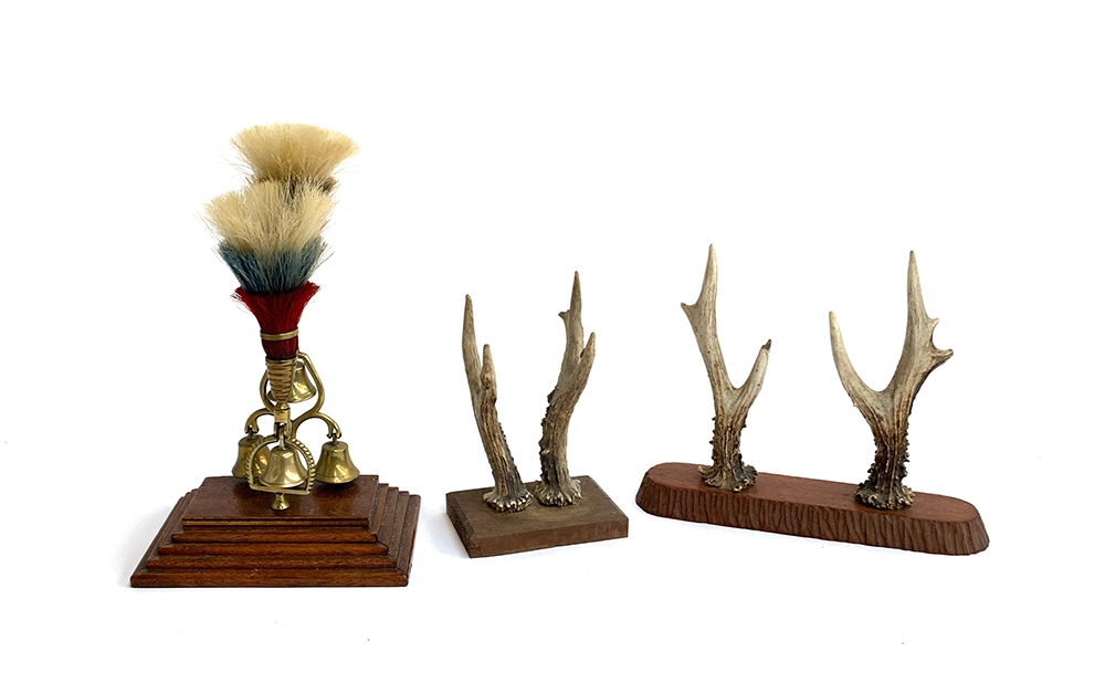 Two pairs of roe deer antlers mounted on wooden plaques; together with a regimental set of brass