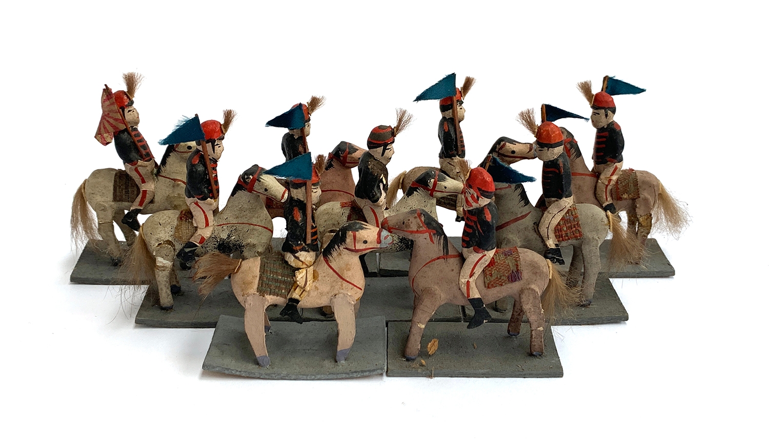 A collection of nine early 20th century model figures, of a Japanese cavalry regiment