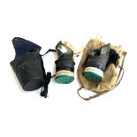 Two WWII gas masks, dated 1939, one with leather case, the other in canvas bag