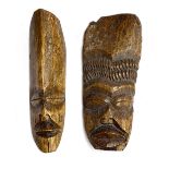 Two African carved bone masks, each approx. 28cm high