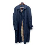 An Austin Reed navy raincoat, with check lining, 46" chest, of Burberry hanger