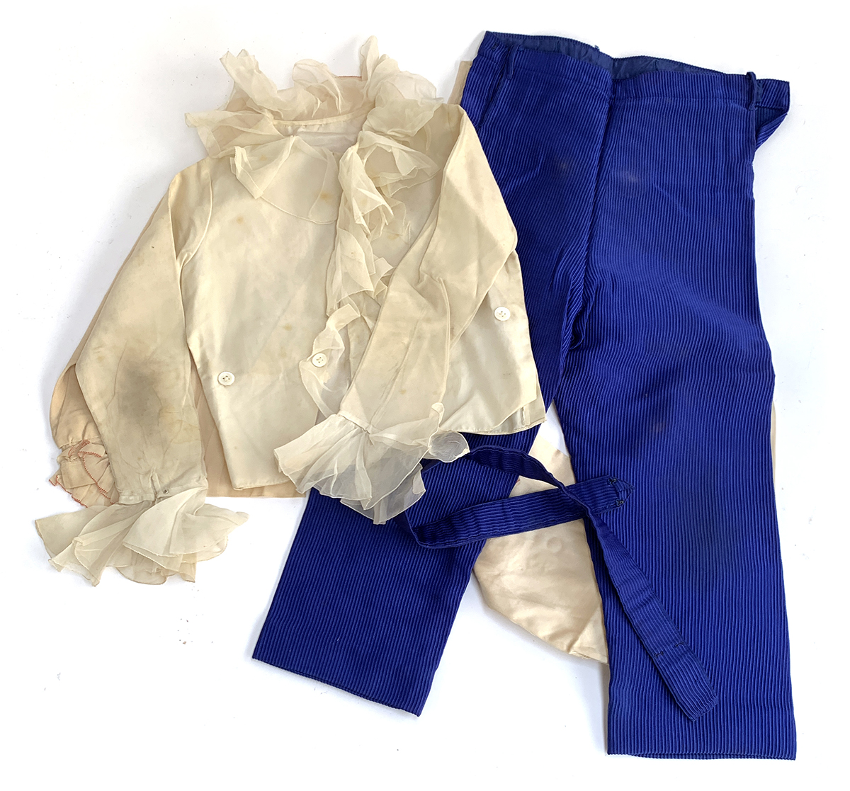 A pair of page boy trousers together with two jackets, each with lace collars and trim, and a pair o