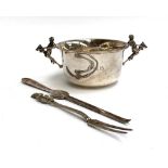 A silver tastevin, the twin handles in the form of jockeys astride hobby horses, Mappin & Webb,