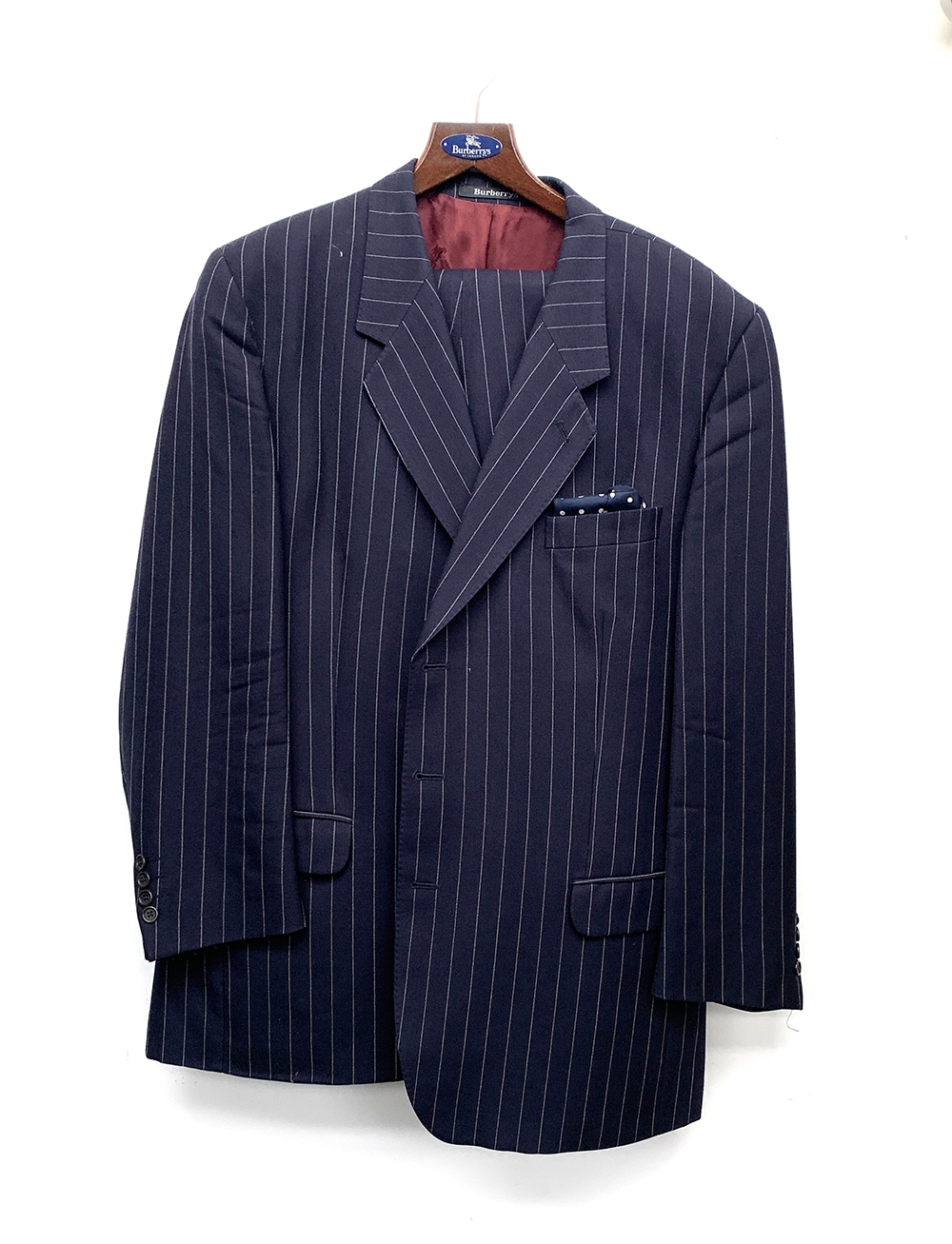 A Burberry's navy wool single breasted suit, chest 44, with two pairs of trousers, on a Burberry's