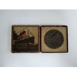 An RMS Lusitania replica German medal, with original box