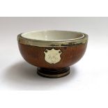 A ceramic lined wooden presentation bowl, with plated foot, rim, one vacant plaque, the other
