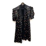 A black silk and zodiac sign over jacket, size 8; together with a reversible silk gilet