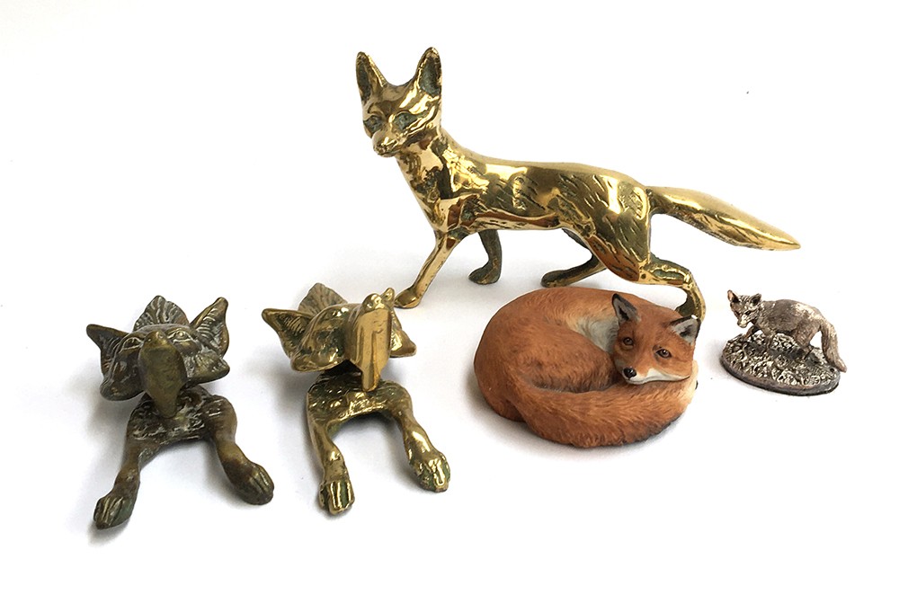 A pair of knockers in the form of fox masks; a brass fox figurine and two other fox figures