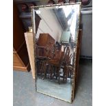 A gilt framed rectangular mirror with bevelled glass, 44x92cm
