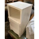 A white painted bedside cabinet with cupboard door