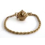 A 9ct gold ropetwist bracelet, 18.5cmL, approx. 1.8g; together with a 9ct gold teapot charm, approx.