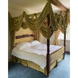 A French four-poster bed, carved headboard and spiral turned posts, with green silk hangings,