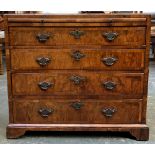 A Georgian and later walnut veneer bachelor's chest, cross and featherbanded, comprising brushing