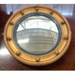 A circular convex gilt framed mirror with bobble moulding, 35cmD