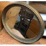 A gilt framed oval wall mirror, 58x48cm