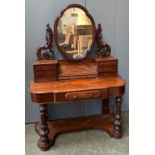 A Victorian mahogany duchess dressing table, shaped adjustable mirror on heavily carved supports,