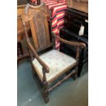 An 18th century oak open armchair, with carved and caned back, upholstered seat, on block turned