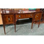 A Regency mahogany sideboard, two central drawers flanked by cupboard doors, with bell flower