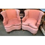 A pair of pink upholstered wingback armchairs with shaped fronts, each 84cmW