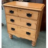 A small pine chest of three drawers on turned legs, 74x42x89cmH