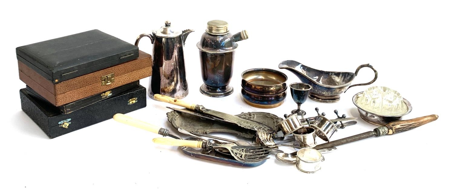 A mixed lot of plated items to include cocktail shaker; a pair of wine coasters; coffee pot; gravy